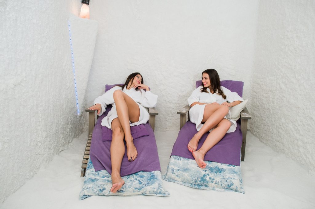 Two women relaxing in a salt cave at Halotherapy
